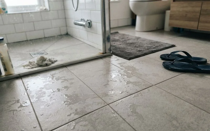 A textured, matte-finish tile floor being installed in a bathroom for better slip resistance